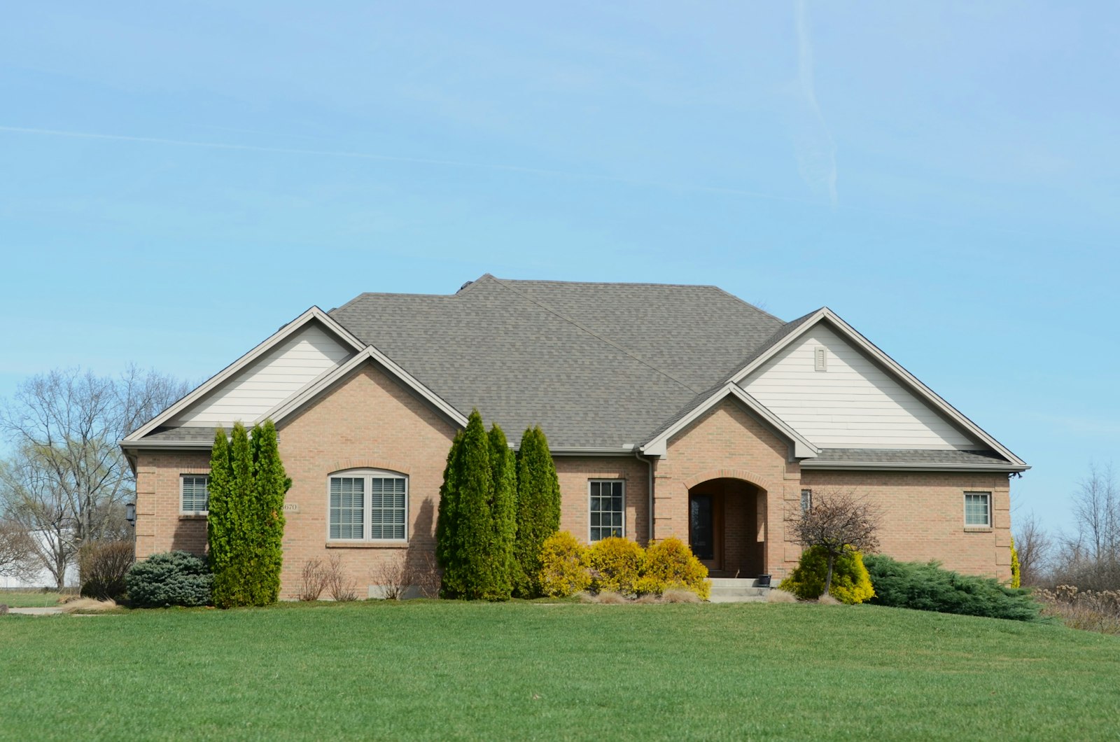 Full property maintenance shot — cut lawn, clean beds, trimmed shrubs