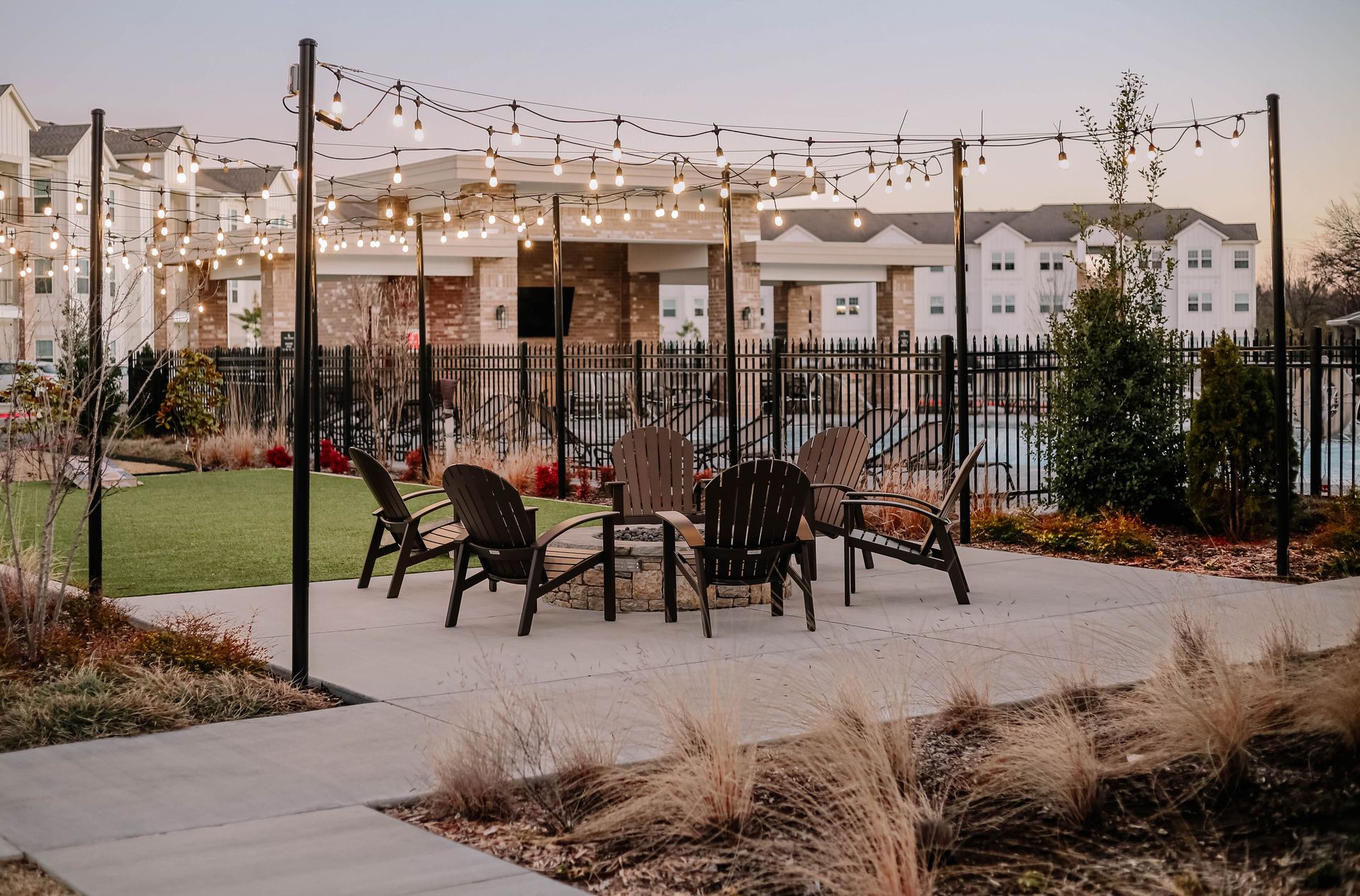 Paver patio with outdoor furniture and warm string lights at dusk